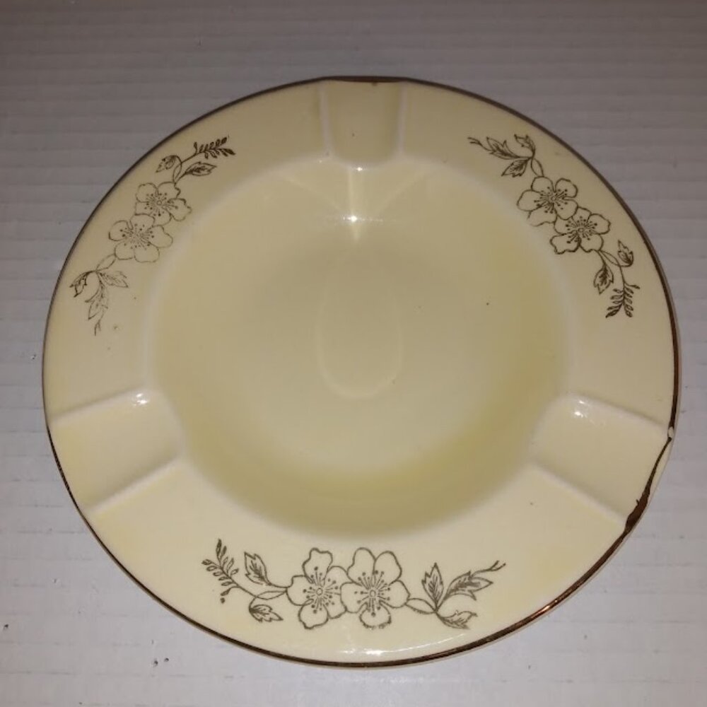 Pearl China Co.: Yellow ashtray hand decorated floral design, 22ct. gold.
